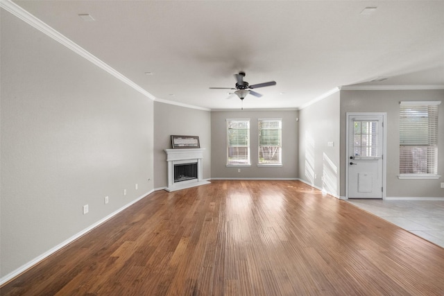 unfurnished living room featuring light wood-type flooring, ceiling fan, and crown molding