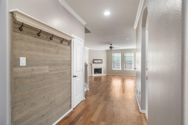 hall with hardwood / wood-style flooring and ornamental molding