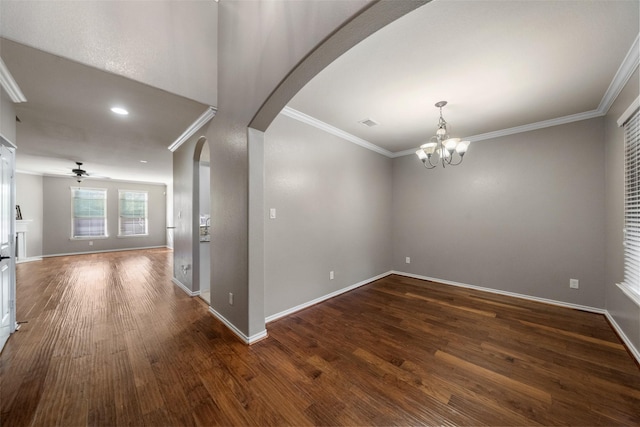 empty room featuring dark hardwood / wood-style flooring, ceiling fan with notable chandelier, and ornamental molding