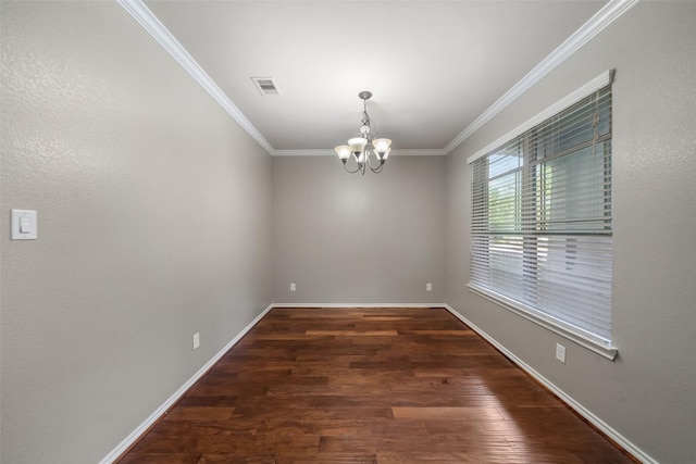 spare room with a chandelier, dark hardwood / wood-style flooring, and crown molding