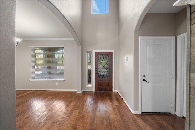 entryway featuring ornamental molding and dark wood-type flooring