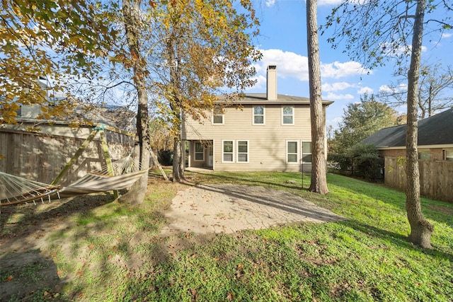 rear view of property with a lawn