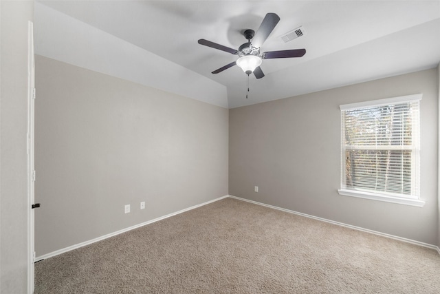 carpeted empty room with ceiling fan and lofted ceiling