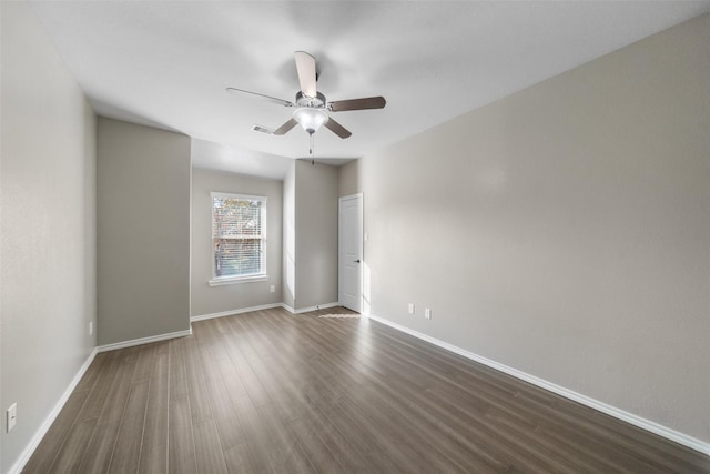 unfurnished room with ceiling fan and dark wood-type flooring