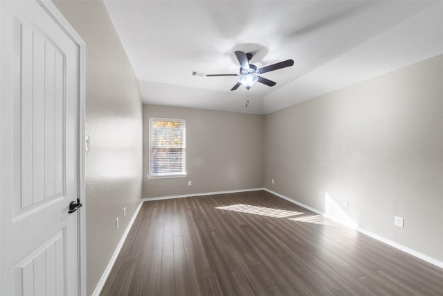 spare room featuring ceiling fan, dark hardwood / wood-style flooring, and lofted ceiling