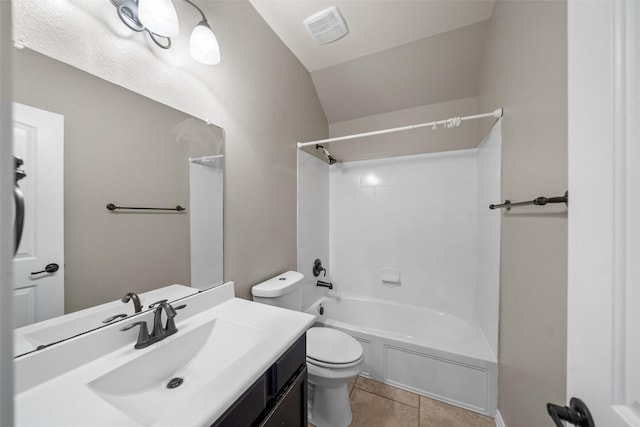 full bathroom with vanity, vaulted ceiling, shower / bathing tub combination, tile patterned flooring, and toilet