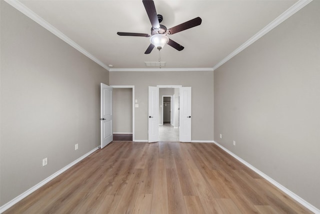 empty room with crown molding, ceiling fan, and light hardwood / wood-style floors