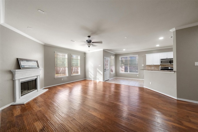 unfurnished living room featuring light hardwood / wood-style flooring, ceiling fan, and crown molding