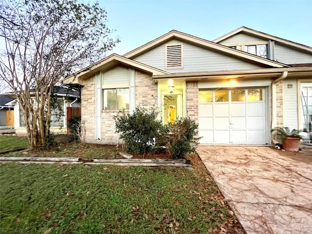 view of front of house with a garage and a front lawn