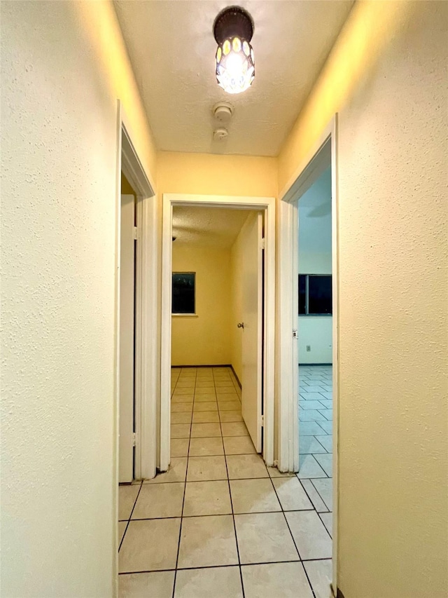 hall with light tile patterned floors