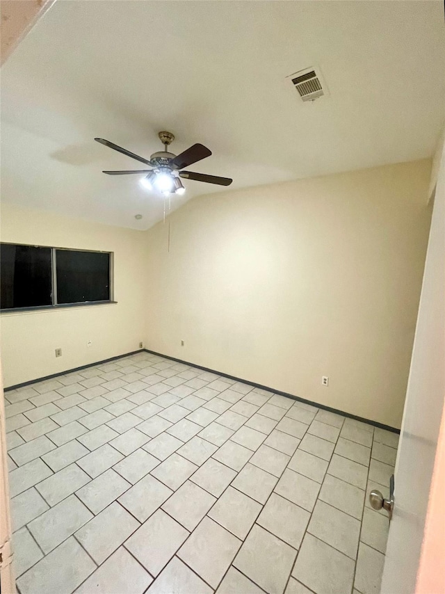 spare room with ceiling fan and light tile patterned flooring