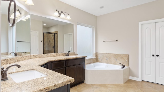 bathroom featuring tile patterned flooring, vanity, and plus walk in shower