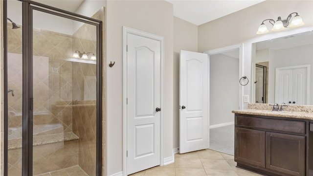 bathroom with tile patterned flooring, vanity, and a shower with door