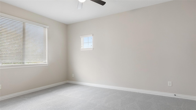 carpeted empty room featuring plenty of natural light and ceiling fan