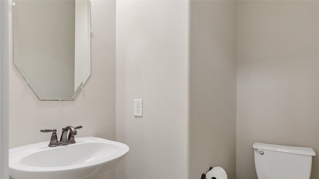 bathroom with toilet and sink