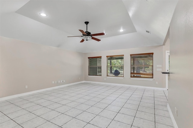 unfurnished room featuring ceiling fan, light tile patterned flooring, and vaulted ceiling