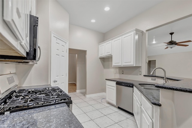 kitchen featuring dishwasher, white cabinets, sink, light tile patterned floors, and white gas stove