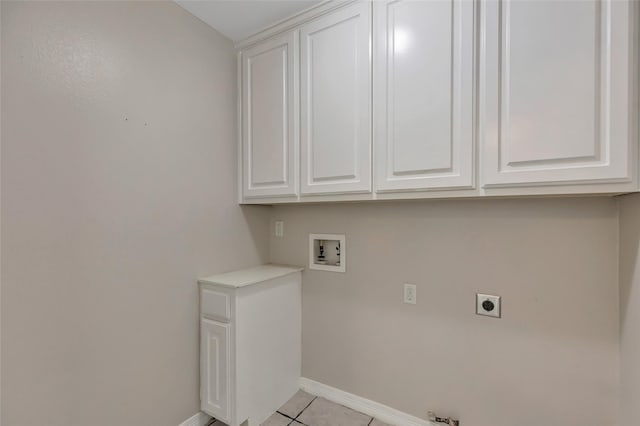 washroom with electric dryer hookup, hookup for a washing machine, light tile patterned flooring, and cabinets