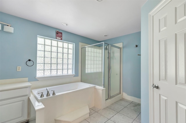 bathroom with tile patterned flooring, vanity, and plus walk in shower