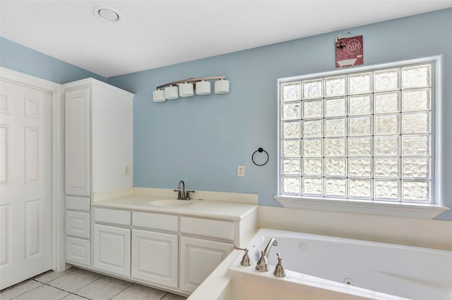 bathroom with vanity, tile patterned floors, and a bathtub