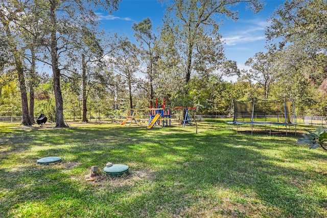 view of yard with a playground and a trampoline