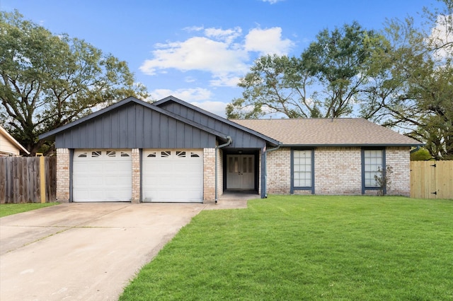 view of front of home featuring a front yard, brick siding, fence, and an attached garage