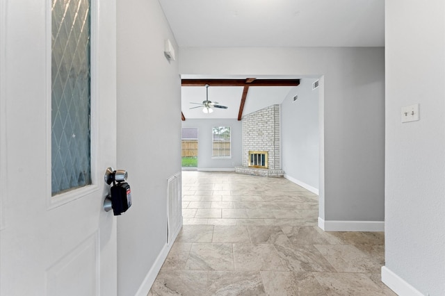 hall featuring visible vents, beamed ceiling, and baseboards