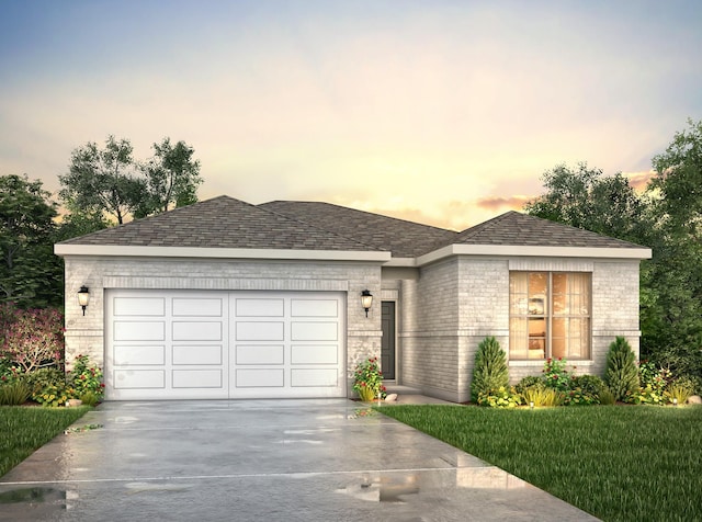 view of front of property with a garage and a lawn