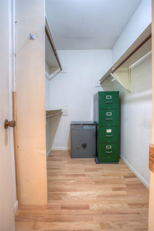 walk in closet with light wood-type flooring