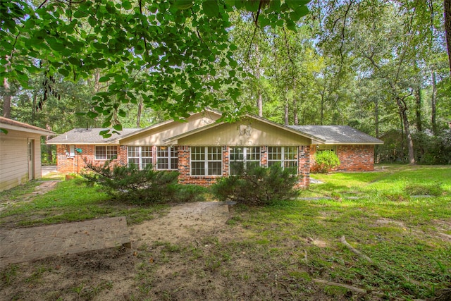 view of front of property with a front yard and brick siding