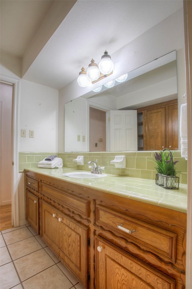 bathroom with vanity, decorative backsplash, and tile patterned floors