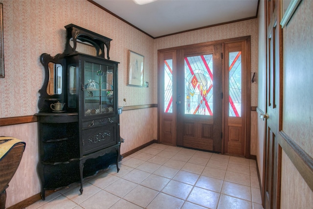 foyer entrance featuring light tile patterned floors and ornamental molding