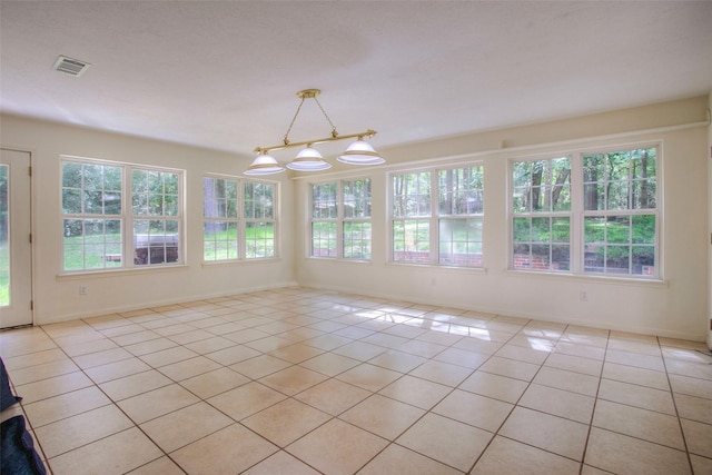 unfurnished sunroom featuring visible vents