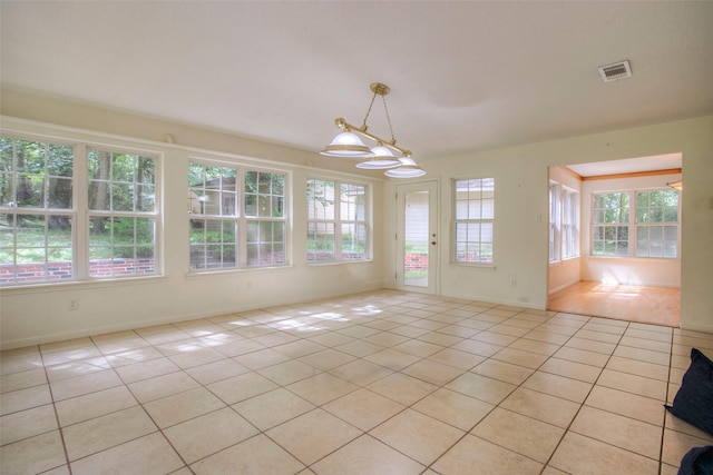 interior space featuring light tile patterned floors, baseboards, and visible vents