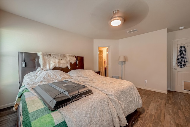 bedroom with dark hardwood / wood-style floors and ceiling fan