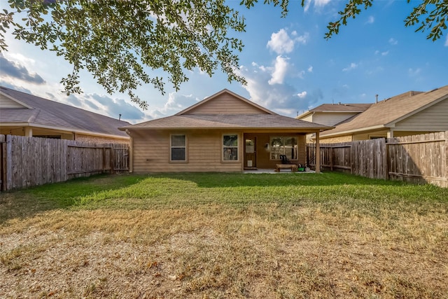 rear view of property with a lawn