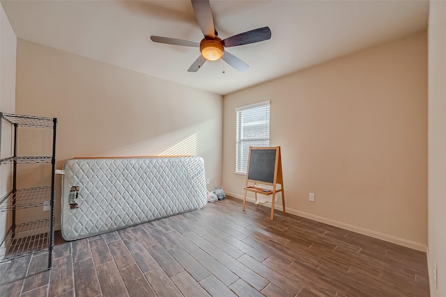 interior space with ceiling fan and dark hardwood / wood-style flooring