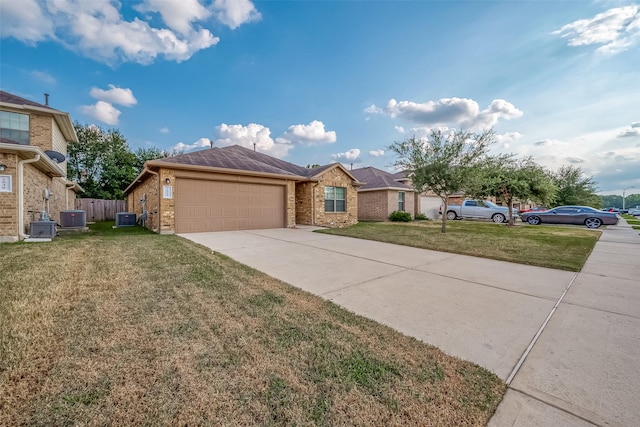 ranch-style home with a front yard, central AC, and a garage