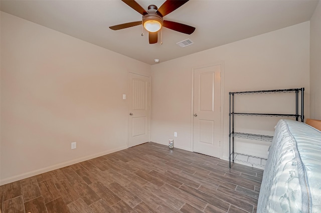 unfurnished bedroom with hardwood / wood-style flooring and ceiling fan