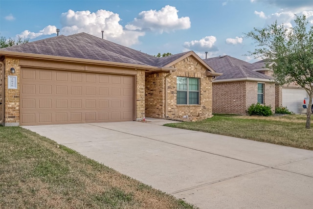 ranch-style house featuring a garage and a front lawn