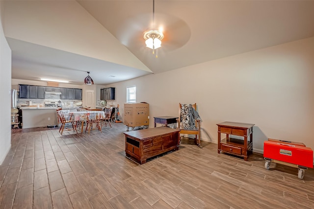 interior space with hardwood / wood-style floors, ceiling fan, and high vaulted ceiling