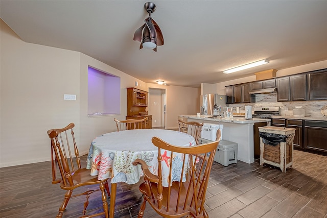 dining space with dark hardwood / wood-style floors