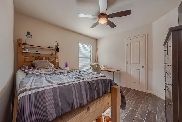 bedroom with dark hardwood / wood-style floors and ceiling fan