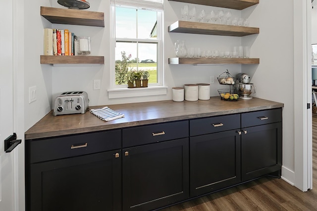 bar with dark hardwood / wood-style floors