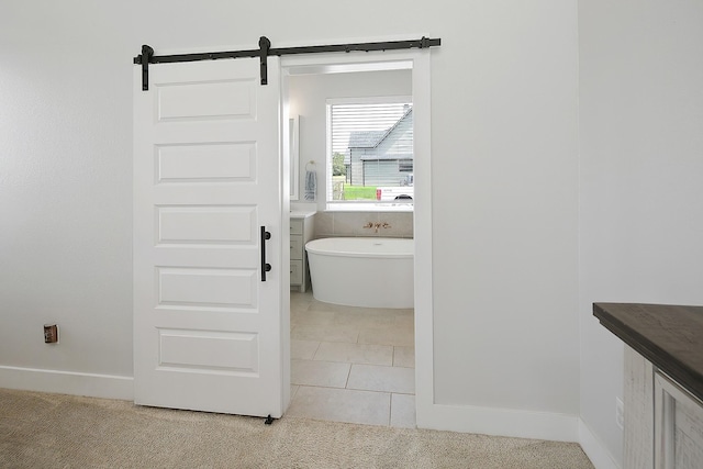 bathroom with a bathing tub, tile patterned flooring, and vanity