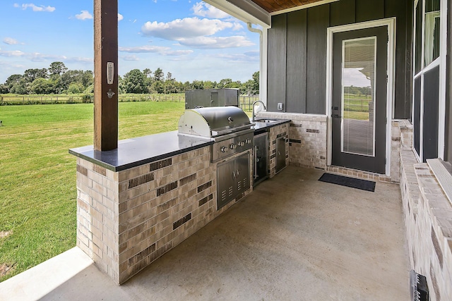 view of patio / terrace with sink, a grill, and exterior kitchen