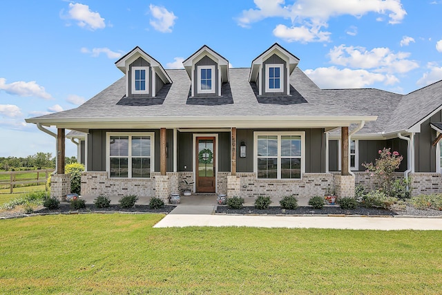 view of front of house featuring a porch and a front lawn