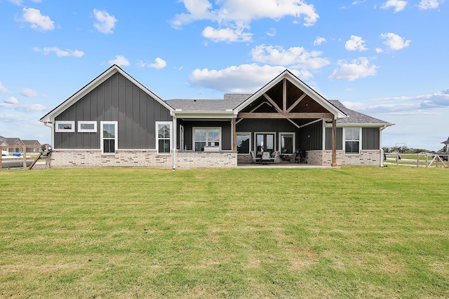 rear view of house with a yard and a patio