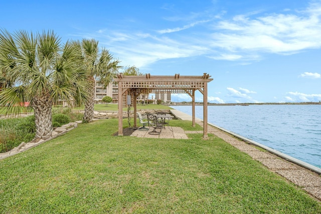 view of dock with a yard and a water view