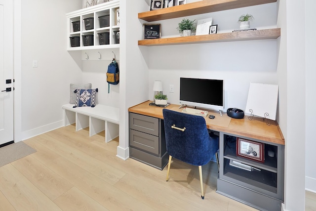 office featuring light hardwood / wood-style flooring and built in desk